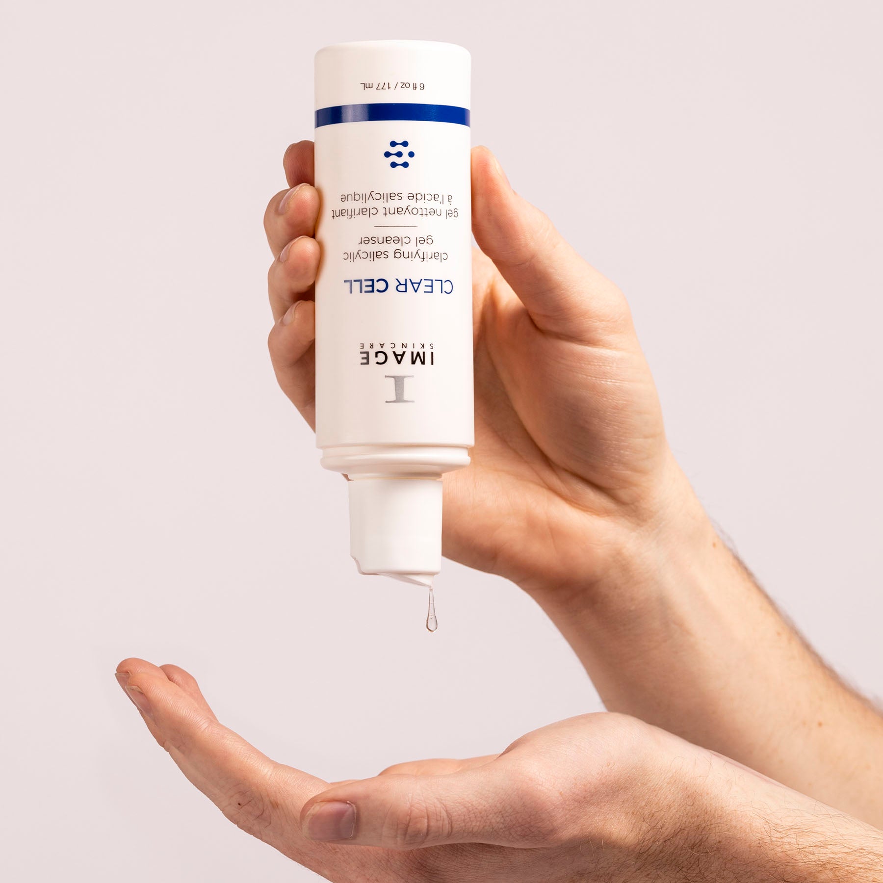 Pouring clarifying salicylic acid cleanser into hand