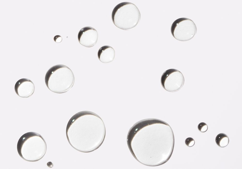 Clear water droplets on a white background